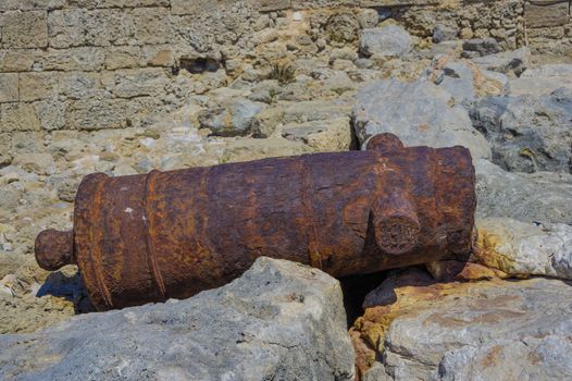 old rusty cannon lies on the coastal rocks from the time of the historical wars