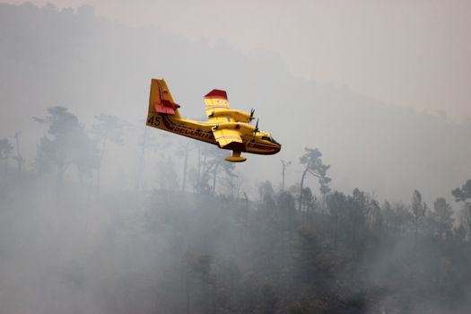 Menton, France - September 9, 2015: Canadair CL-415 (Bombardier 415 Superscooper) Airplane Extinguish Forest in Flame in Menton, French Riviera