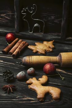 Rolling pin and Christmas homemade gingerbread cookies.Dark key