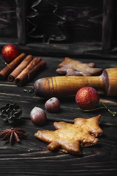 Rolling pin and Christmas homemade gingerbread cookies.Dark key