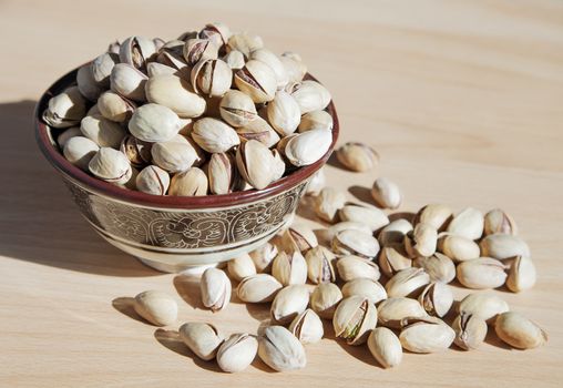 Bowl of pistachio nuts on a table