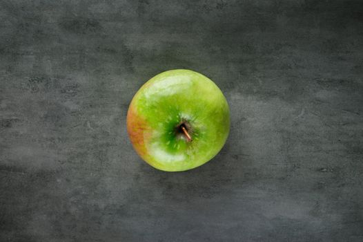 one green apple ripe pears on dark stone background, top view, copy space