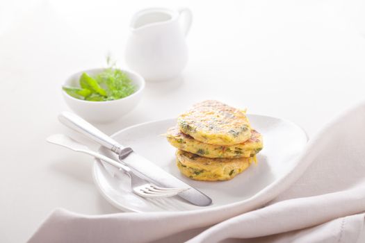 Healthy vegetarian zucchini fritters served on a table