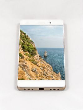 Modern smartphone displaying full screen picture of beautiful natural coastline in Yalta, Crimea. Concept for travel smartphone photography. All images in this composition are made by me and separately available on my portfolio