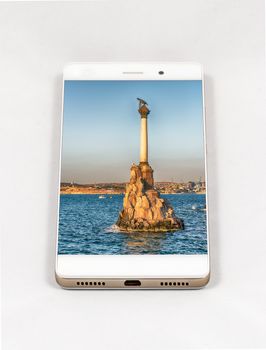 Modern smartphone displaying picture of Sevastopol, Crimea. Concept for travel smartphone photography. All images in this composition are made by me and separately available on my portfolio