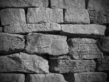 stone wall background with black and white  stones with dark edges