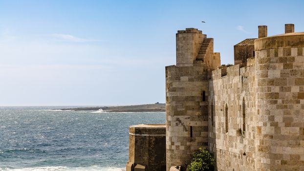 Scenic view of Maniace castle on sea, Syracuse, Sicily, Italy