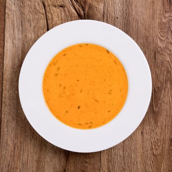 Vegetarian vegetable soup on a wooden table