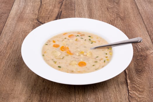 Vegetarian vegetable soup on a wooden table