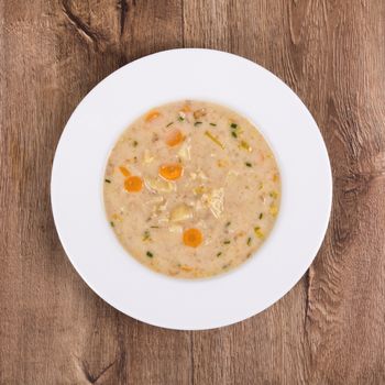 Vegetarian vegetable soup on a wooden table