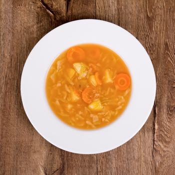 Vegetarian vegetable soup on a wooden table