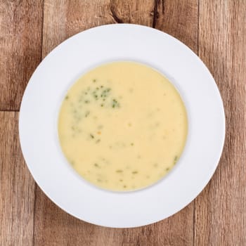 Vegetarian vegetable soup on a wooden table