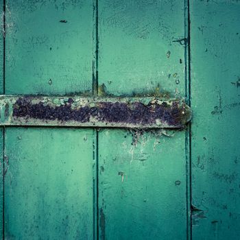 Grungy Rusty Hinge On A Rustic Green Wooden Door