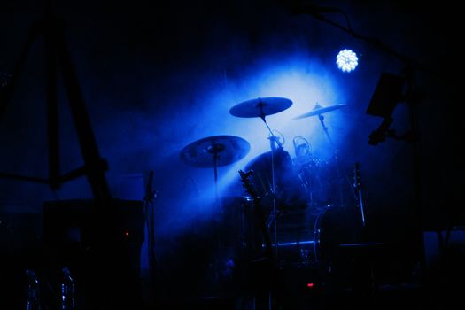 drum in a very dark room with smoke