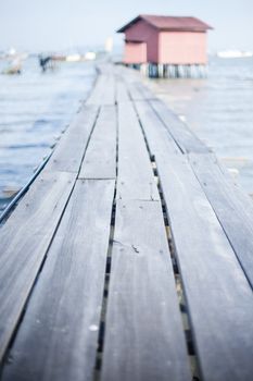 Wooden pier on the sea background, destroyed bridge near tropics. Color panorama