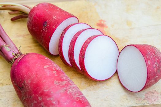 Red radish on wooden table