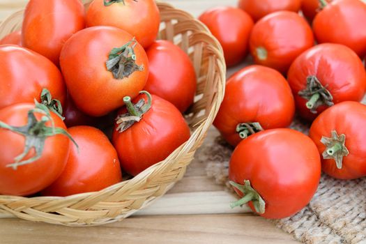 raw tomatoes on wooden table