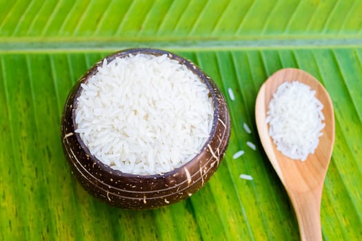 rice in coconut shell on banana leaf