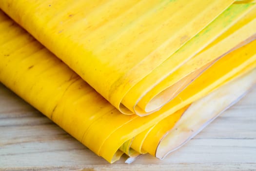 Yellow banana leaf on wooden table