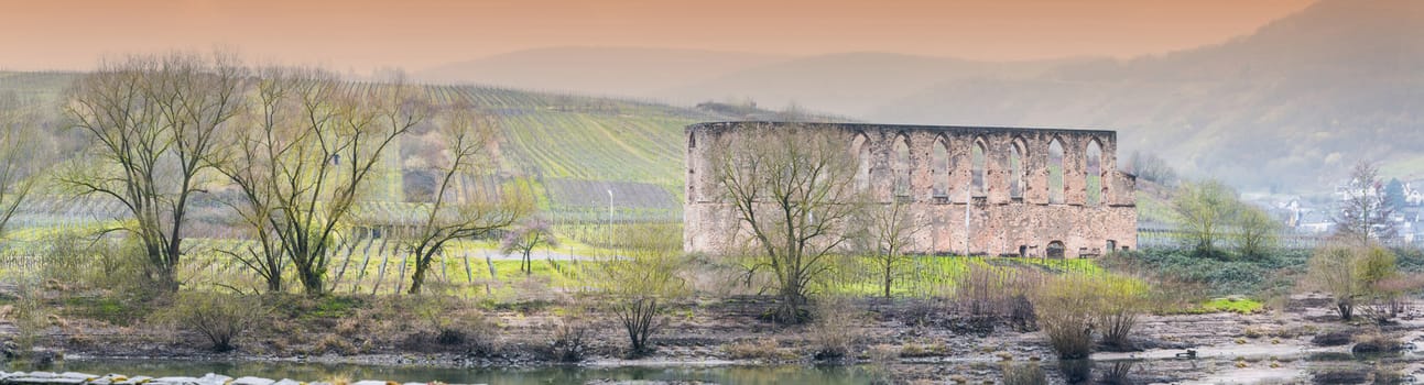 Artistic work of my own. HDR processing.
Panorama, ruins of a monastery in bars, on the Moselle, in the background the vineyard. Shot in the morning fog.
