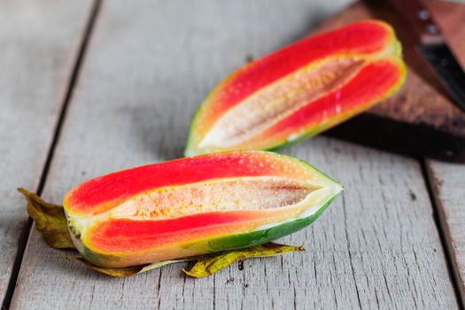 ripe papaya cut in half on the old wooden floor.