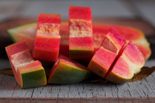 The papaya of slices on the old wooden floor.