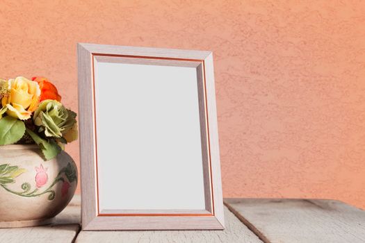 Picture frames and vases on the old wooden table.