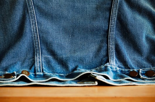 surface of denim jacket on the old wooden table.
