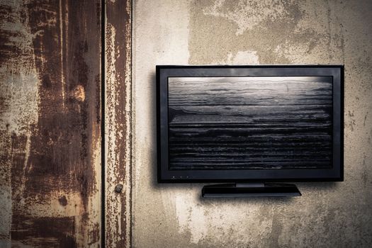 Television of old on a concrete wall.