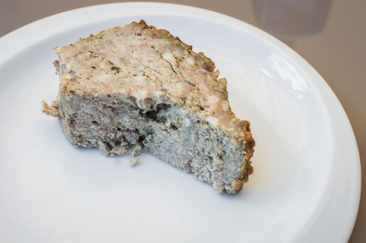 piece rabbit pate in a white plate on the table