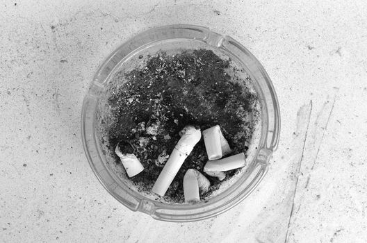 Ashtray full of cigarettes burn