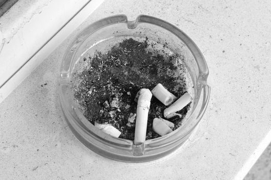 Ashtray full of cigarettes burn