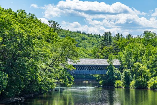 The Henniker Covered Bridge is a covered pedestrian footbridge serving New England College across the Contoocook River in Henniker, New Hampshire.