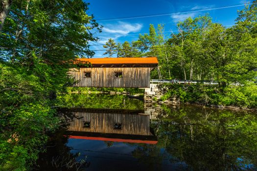 The Waterloo Covered Bridge carries Newmarket Road over the Warner River near the Waterloo Falls in Warner, New Hampshire. The Town lattice truss bridge was built in 1859-60.