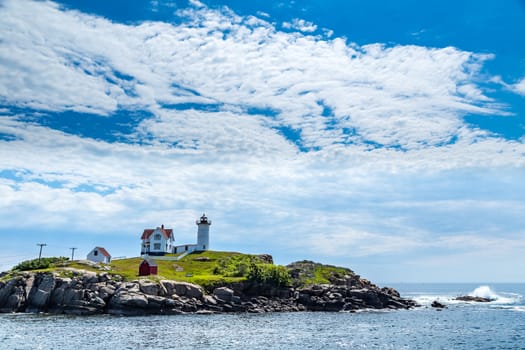 The Cape Neddick Light stands on Nubble Island about 100 yards off Cape Neddick Point. It is commonly known as "Nubble Light" or simply "the Nubble".