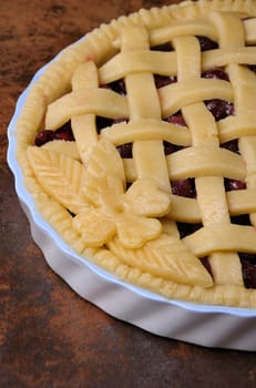 cherry pie dough with decorative ornaments in  roasting pan close-up
