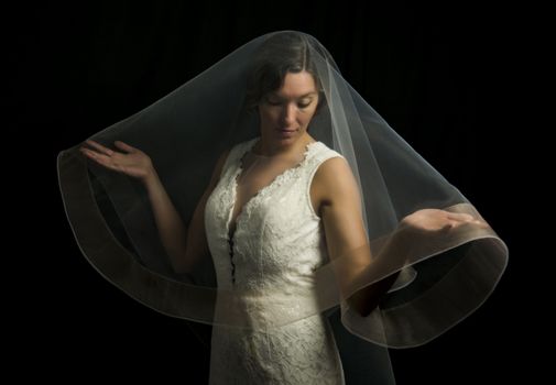 Portrait of a beautiful girl in image of the bride. Photo shot in the Studio on a black background