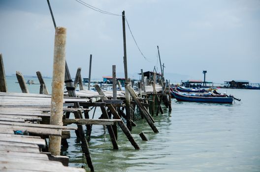 Wooden pier on the sea background, destroyed bridge near tropics. Color panorama