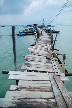 Wooden pier on the sea background, destroyed bridge near tropics. Color panorama