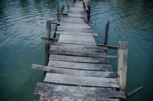 Wooden pier on the sea background, destroyed bridge near tropics. Color panorama