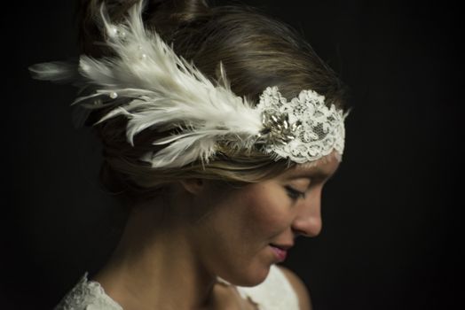 Portrait of a beautiful girl in image of the bride. Photo shot in the Studio on a black background