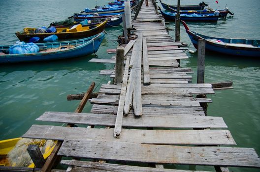 Wooden pier on the sea background, destroyed bridge near tropics. Color panorama