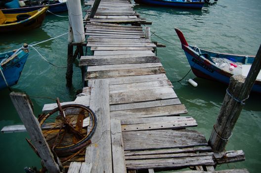 Wooden pier on the sea background, destroyed bridge near tropics. Color panorama