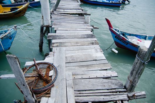 Wooden pier on the sea background, destroyed bridge near tropics. Color panorama