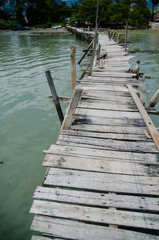 Wooden pier on the sea background, destroyed bridge near tropics. Color panorama