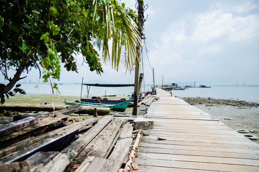 Wooden pier on the sea background, destroyed bridge near tropics. Color panorama