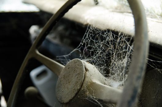 Wheel machines. Part of abandoned old car with cobwebs