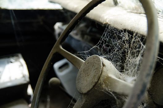 Wheel machines. Part of abandoned old car with cobwebs