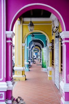 Penang, Malaysia. Color architecture narrow streets with people. Dirty moldy humidity cityscape