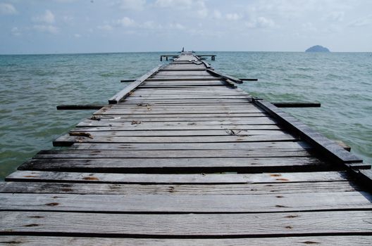 Penang island Malaysia. Wooden pier on the sea background, destroyed bridge near tropics. Color panorama